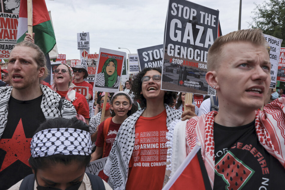 Pro-Palestinian demonstrators hold signs calling for an end to Israel's genocide in Gaza as Prime Minister Benjamin Netanyahu prepares to address a joint meeting of Congress in Washington DC.