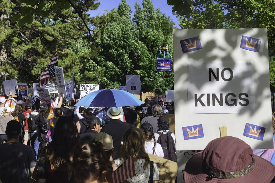 Utah residents hold signs as they join the "No Kings" rally in Salt Lake City on June 14, 2025.