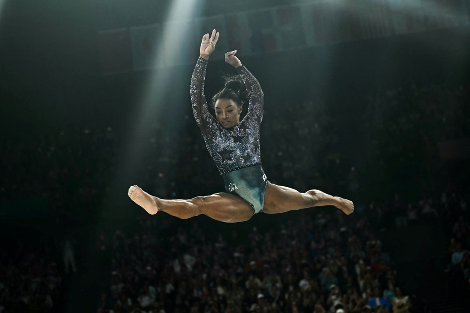 Simone Biles, aiming to add to the four gold medals she won in Rio de Janeiro in 2016, tweaked her left calf warming up for her second apparatus, the floor exercise.