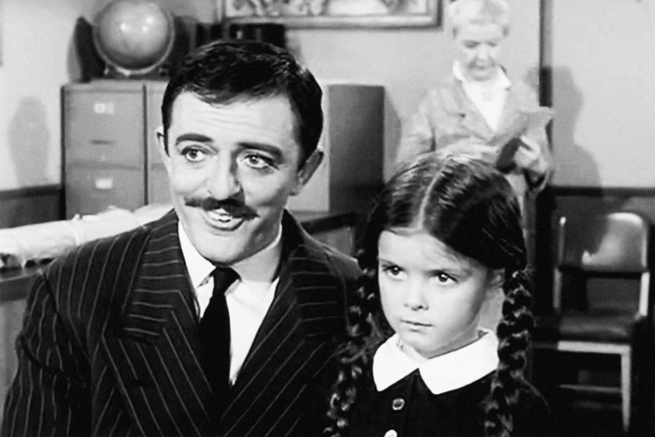 John Astin (92, l.) appears as Gomez Addams and Lisa Loring as Wednesday Addams in the 1964 pilot episode of The Addams Family.