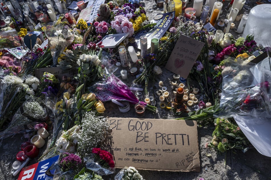 Flowers, signs and momentos are left at a makeshift memorial in the area where Alex Pretti was shot dead by federal immigration agents in Minneapolis, Minnesota, on January 26, 2026.