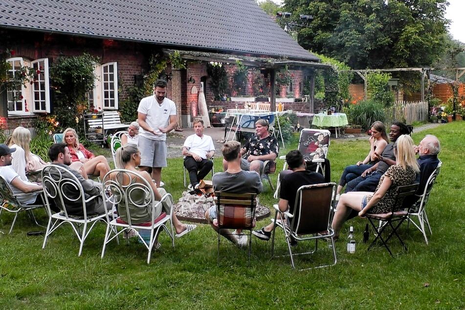 Die "Sommerhaus der Stars"-Kandidaten versammeln sich im Garten.