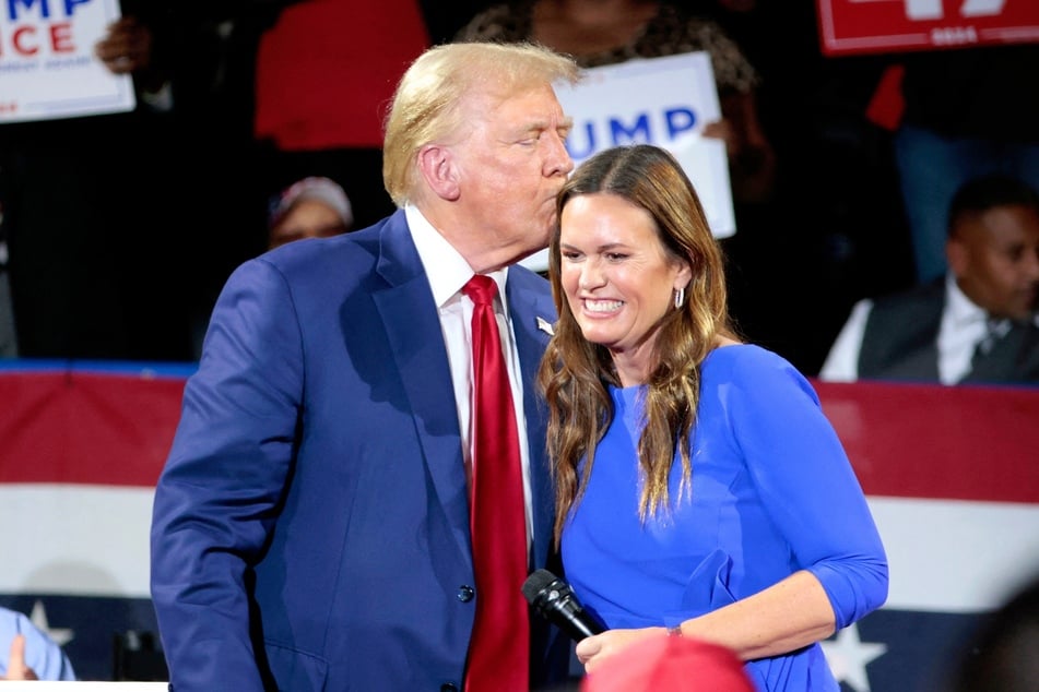 Donald Trump (l.) and Arkansas Governor Sarah Huckabee Sanders during a town hall event at the Dort Financial Center in Flint, Michigan, on September 17, 2024.