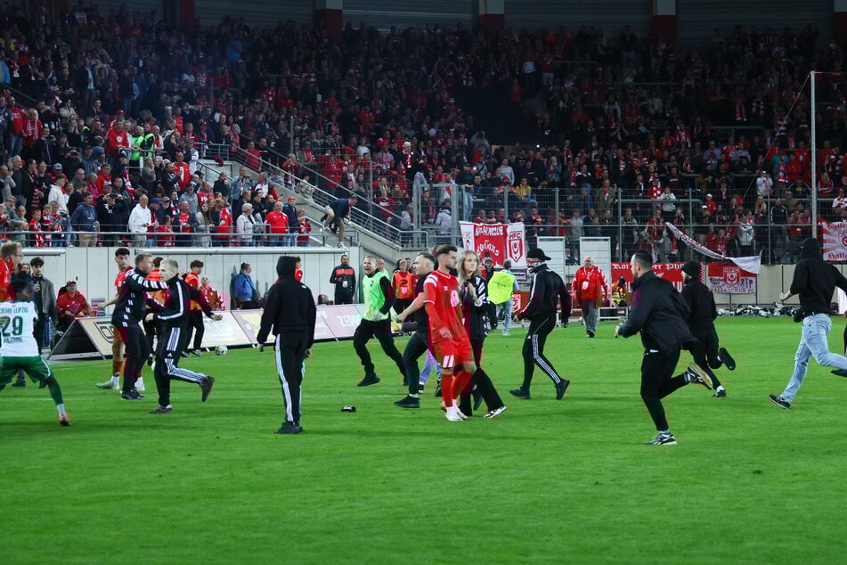 Etwa 100 HFC-Fans stürmten nach dem Spiel auf den Platz und verfolgten die Chemie-Spieler.