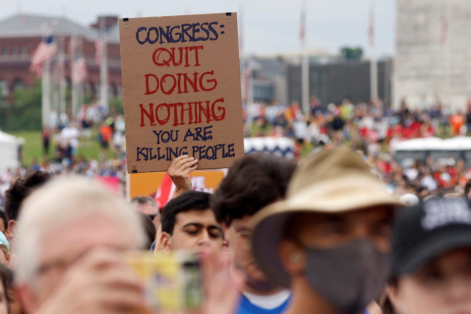A person holds a banner during the March For Our Lives protest at the National Mall in Washington DC.