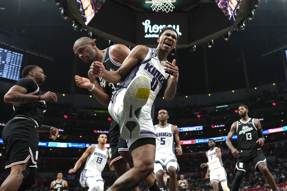 The Sacramento Kings clinched the second-highest scoring game in NBA history as Malik Monk (c.) led them to victory against the Los Angeles Clippers.