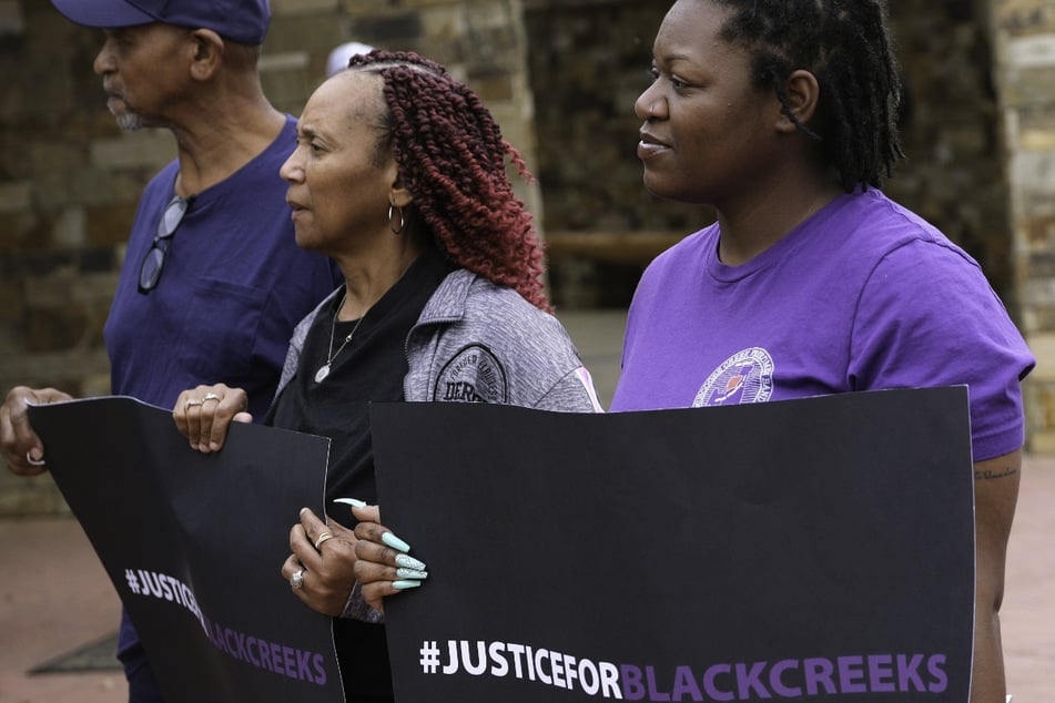 Supporters hold "Justice for Black Creeks" signs at the trial on citizenship rights for Creek Freedmen at the Muskogee Nation District Court in Okmulgee, Oklahoma, on April 4, 2023.