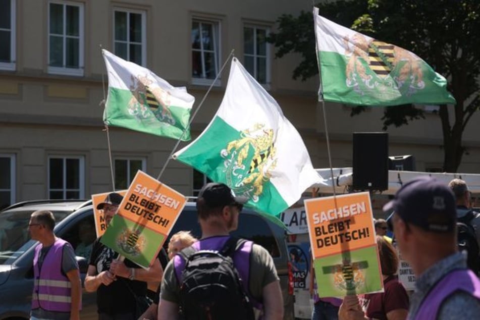 Einige Unterstützer zeigten Fahnen des Königreichs Sachsen und Plakate mit der Aufschrift "Sachsen bleibt deutsch!"