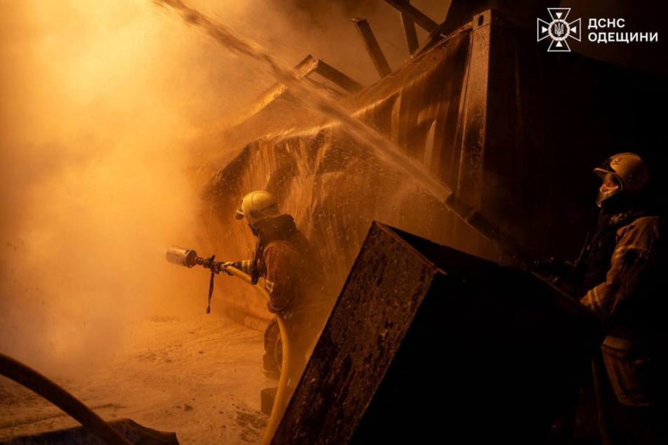 In this handout photograph taken by the Ukrainian Emergency Service and released on Thursday, Ukrainian firefighters extinguish a fire at the site following an air attack in the Odesa region.