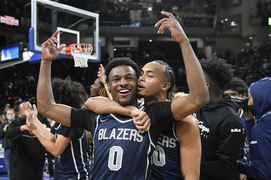 Bronny James and teammate celebrating game win.