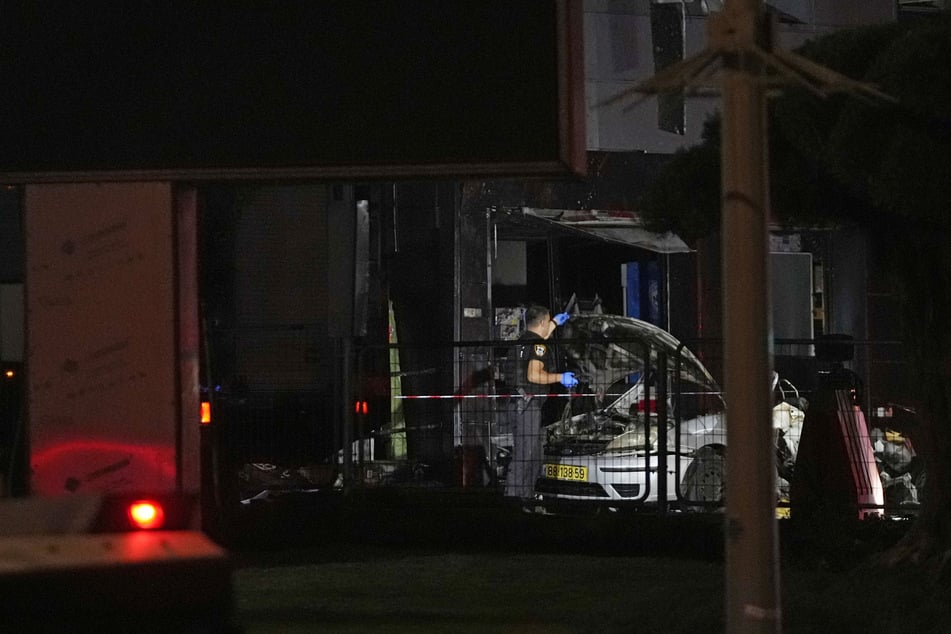 Israelische Sicherheitskräfte untersuchen ein Auto nach einer Explosion an einer Tankstelle in der Nähe der Westbank-Siedlung Karmei Tzur.