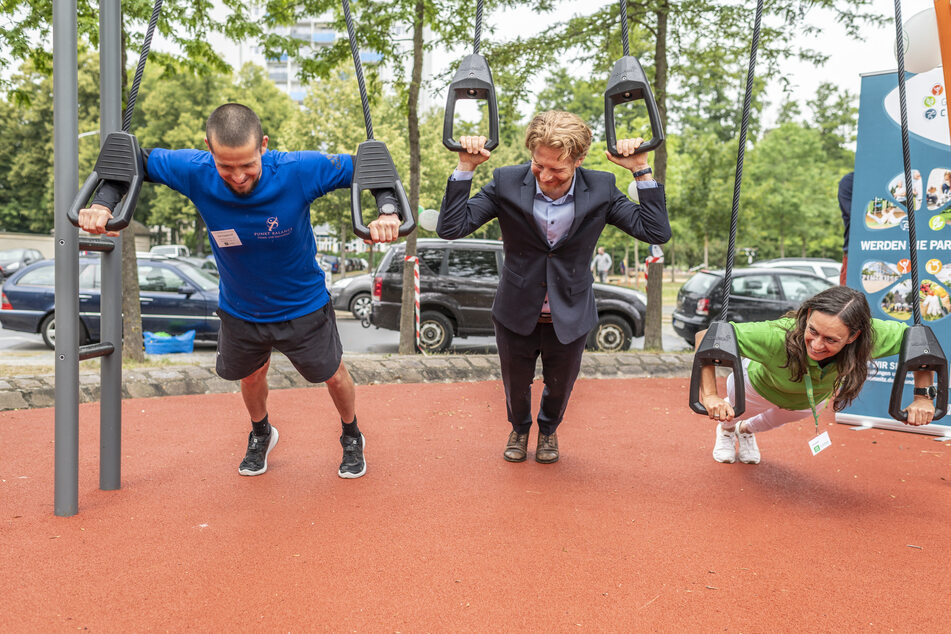Trainer Axel Engelhardt (47), Michael Stötzer (47, Grüne) und Ute Jochmann (56, v.l.) von der AOK Plus testen die Schlingen.