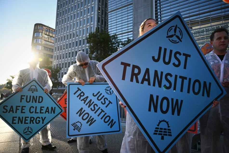 Activists protest against investment in fossil fuels outside of the World Bank headquarters in Washington DC.