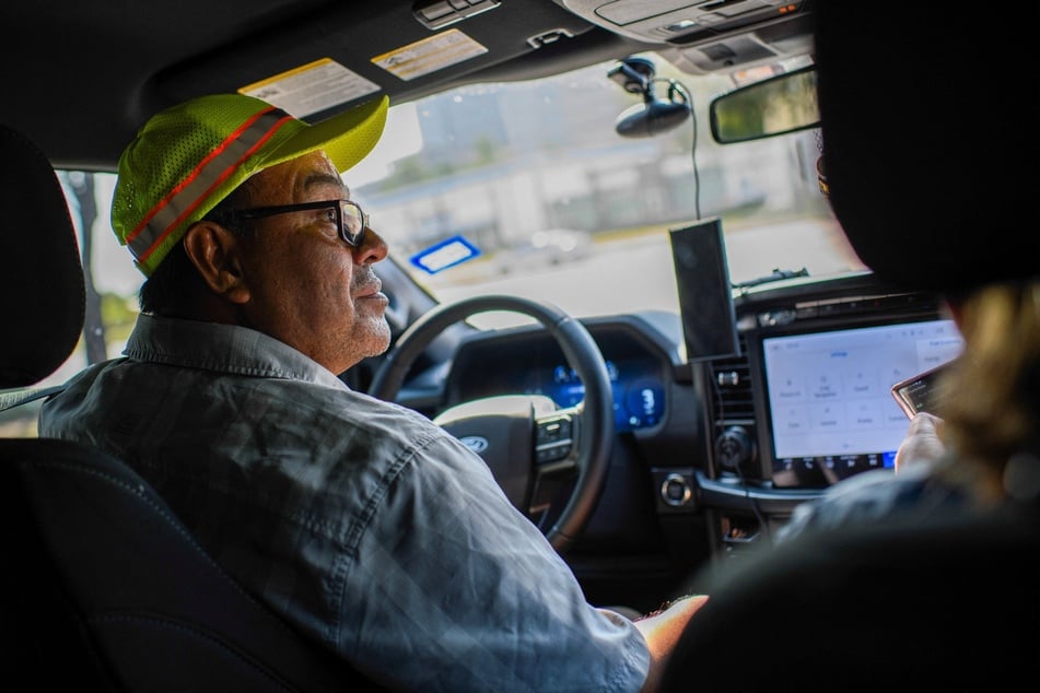 Francisco Mendoza of Alianza Latina Internacional drives around a parking lot while tracking ICE operations in Houston, Texas, on September 17, 2025.