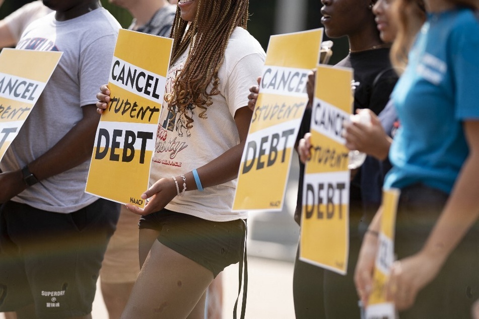Activists rally for student debt cancellation outside the White House in Washington DC.