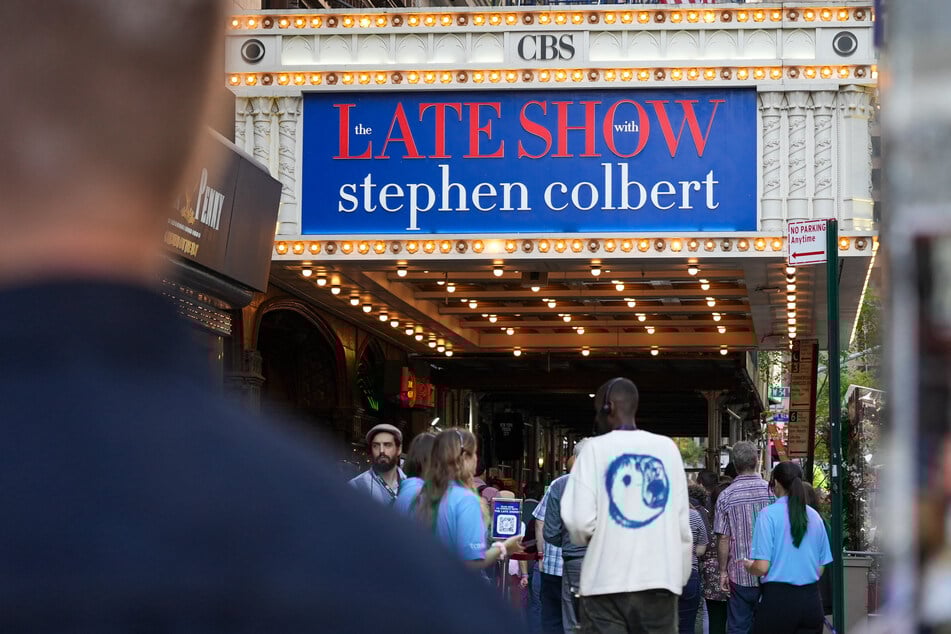 Audience members line up outside of The Late Show With Stephen Colbert in New York City.