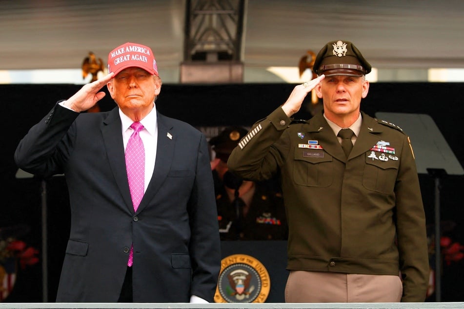 President Donald Trump (l.) and superintendent Lieutenant General Steven W. Gilland salute graduates of the US Military Academy at West Point on Saturday, May 24, 2025.