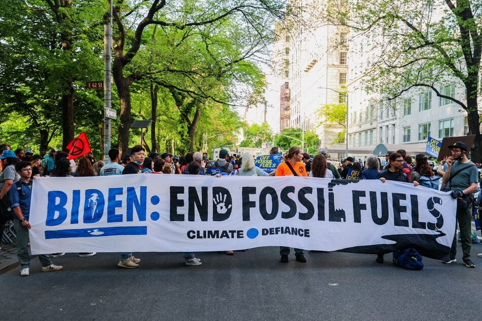 Climate Defiance protesters block a portion of Fifth Avenue demanding President Joe Biden end federal fossil fuel projects.