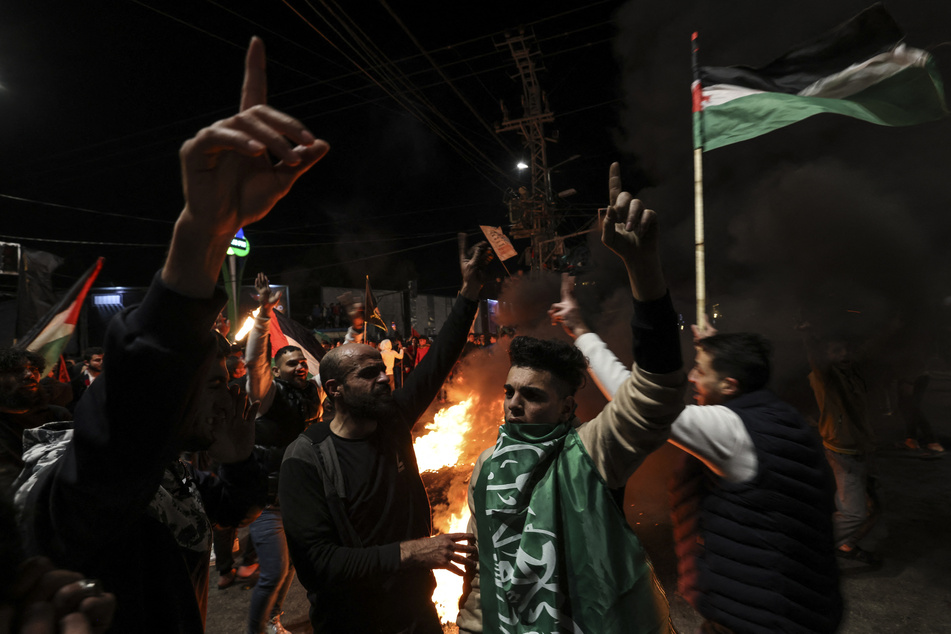 Palestinians react to the news of an attack on an Israeli synagogue.