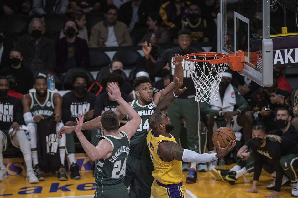 Giannis Antetokounmpo trying to block the Lakers' LeBron James during the Bucks' win in LA.