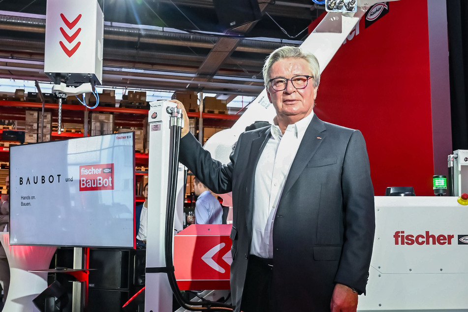Klaus Fischer, Inhaber der Unternehmensgruppe Fischer, steht vor einem BauBot.