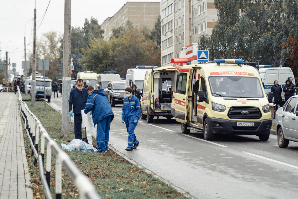 Medics gather at the body of a victim near the scene of a shooting at a school in Izhevsk on Monday.