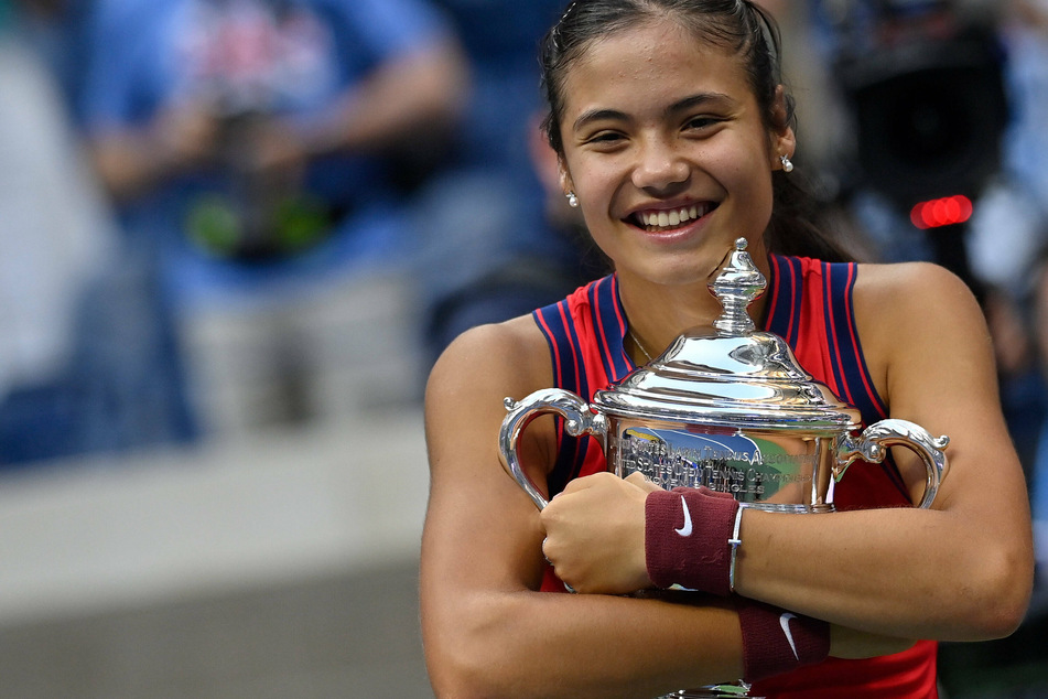 Emma Raducanu hugs the US Open trophy after her historic win.