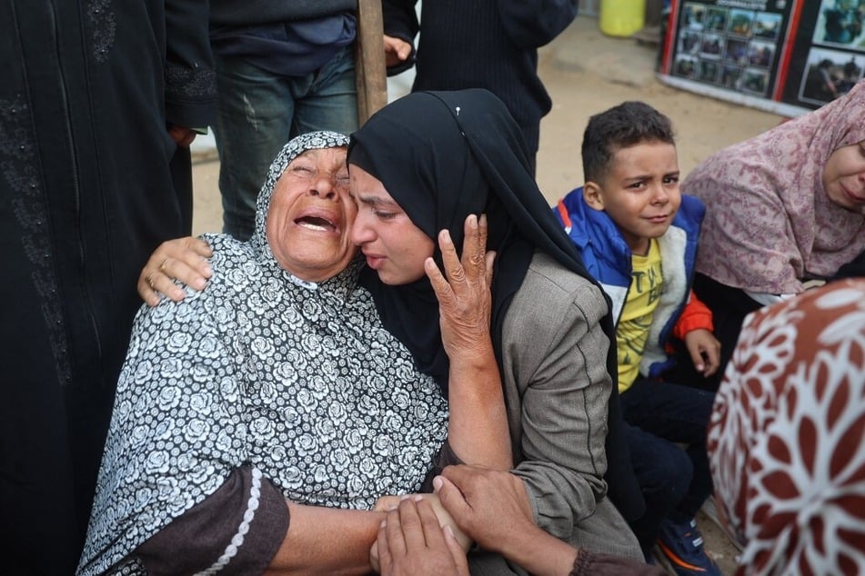 Palestinians at the the Al Aqsa Martyrs hospital mourn relatives killed in an Israeli strike on a tent camp in Deir el-Balah in the central Gaza Strip on November 5, 2024.