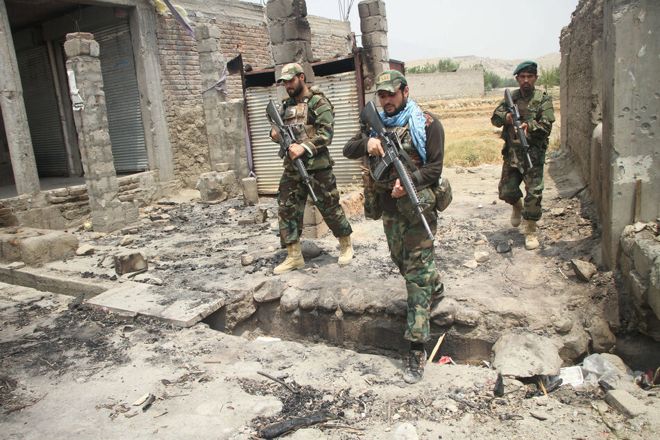 Afghan security force members take part in a military operation against the Taliban.
