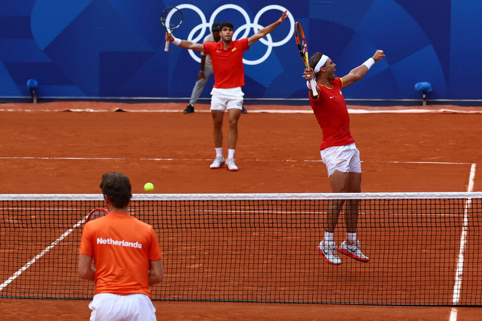 Carlos Alcaraz and Rafael Nadal of Spain celebrate after winning their match against Tallon Griekspoor and Wesley Koolhof of the Netherlands.