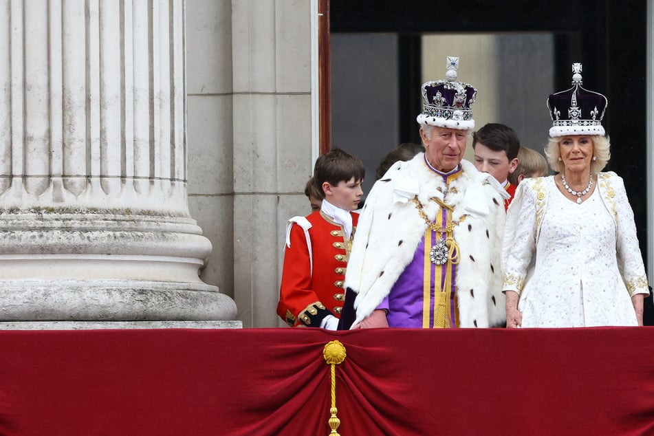 Coronation of King Charles III: Royal couple salute crowd at Buckingham Palace