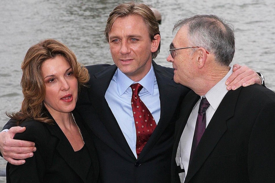 Daniel Craig (c) was introduced as the new 007 at a 2005 press conference, where he appeared alongside Bond producers Barbara Broccoli (l) and Michael G. Wilson (r).