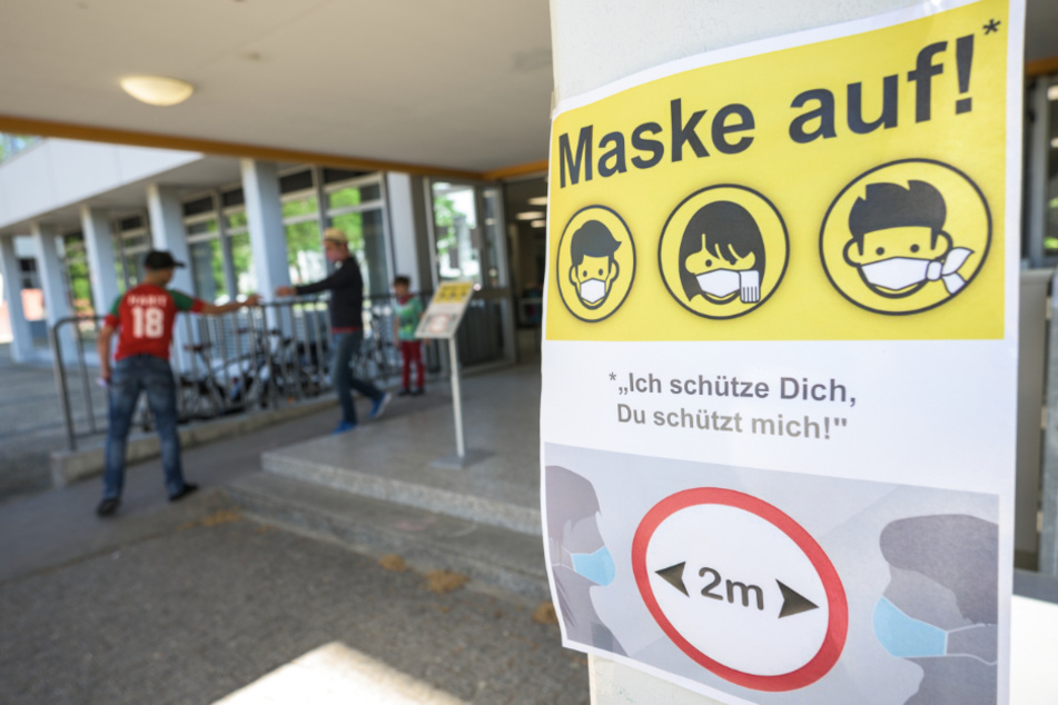 Ein Plakat weist auf die Maskenpflicht in der Berufsbildenden Schule 1 Gewerbe und Technik (BBS1) in Mainz hin.