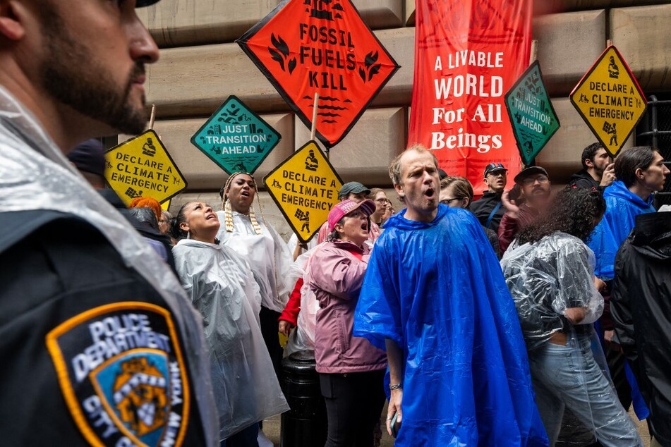 Climate activists hold a demonstration in the Financial District of Manhattan to demand an end to fossil fuel funding by Wall Street and the American government on September 18, 2023, in New York City.