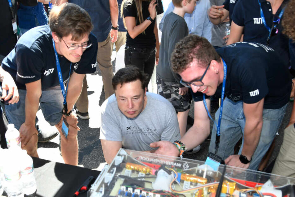 Münchner Studenten der TU München zeigen Elon Musk (M), Vorstandsvorsitzender von Space Exploration Technologies Corp. (SpaceX), bei einem Hyperloop-Wettbewerb ihre Kapsel.