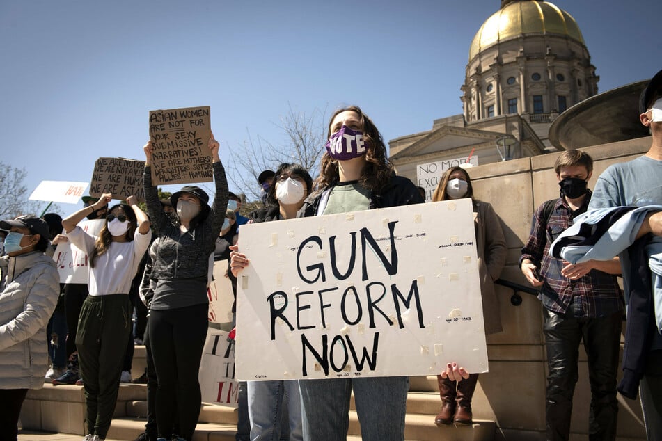 A woman advocating for stricter gun contro at a protest in Atlanta, Georgia, in the wake of a mass shooting that killed eight people, six of whom were Asian American women.