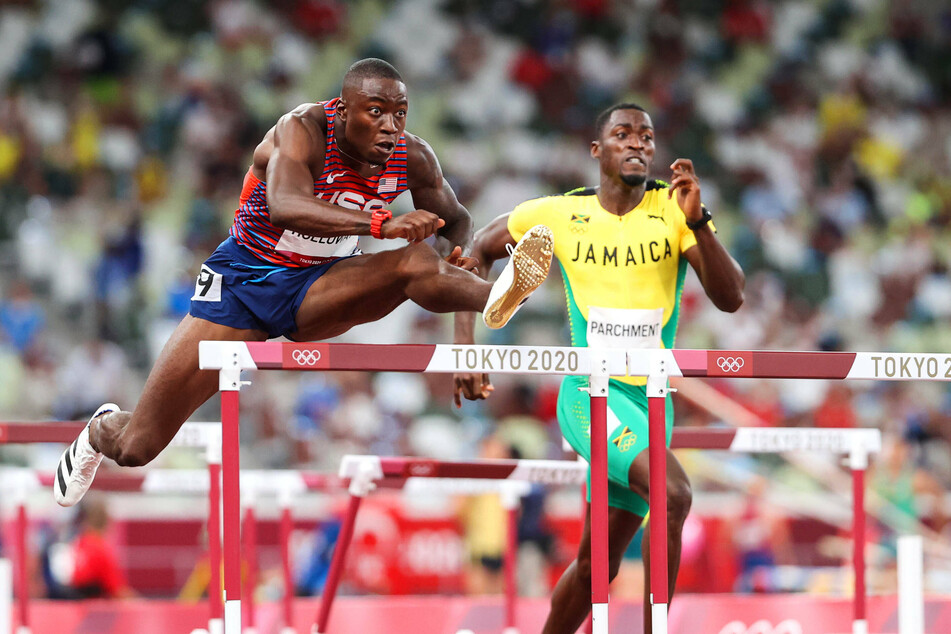 USA's Grant Holloway (L) finished in second place in the men's 110-meter hurdles final on Thursday.