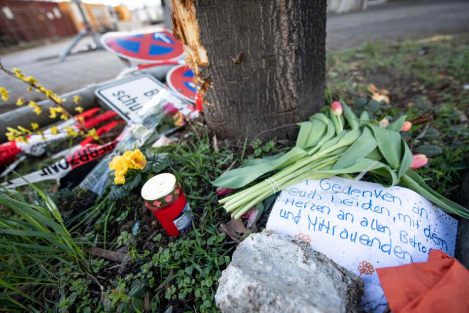 Verbogene Verkehrssschilder und eine Trauernachricht liegen an der Unfallstelle in der Rosensteinstraße in Stuttgart.