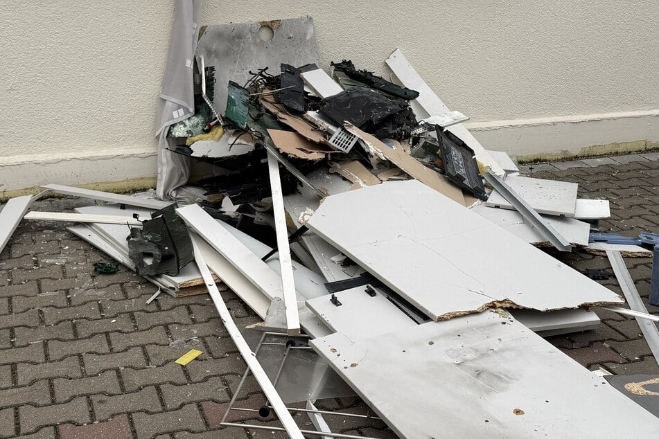 Trümmerteile liegen vor der Sparkasse verteilt.