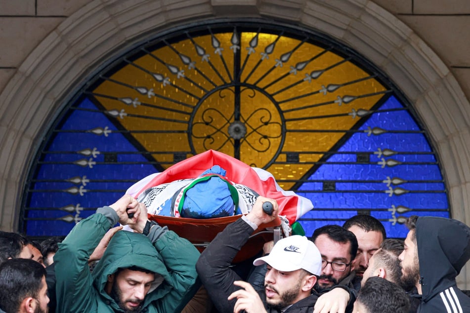 Palestinians carry the body of one of four members of the same family – two children and their parents – killed by Israeli soldiers during a funeral in the West Bank's northern town of Tammun on March 15, 2026.