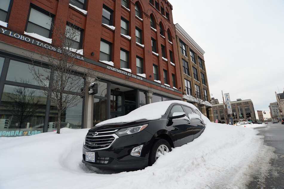 A snowed-in car sits on the street in Buffalo, New York.