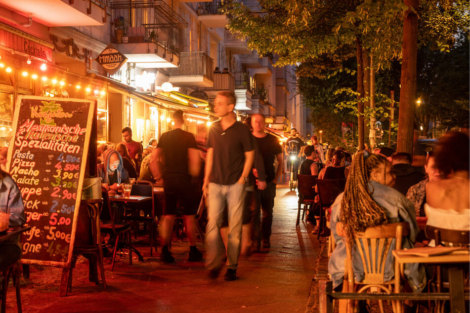 Menschen sitzen in Restaurants und Bars in Berlin-Friedrichshain.