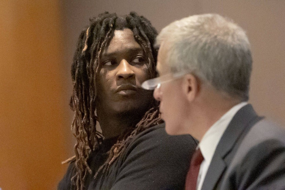 Young Thug sits alongside his lawyer Brian Steel during jury selection in his racketeering case.