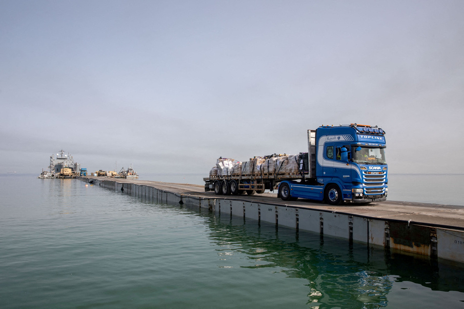 A truck carries humanitarian aid across Trident Pier, a temporary pier to deliver aid, off the Gaza Strip.