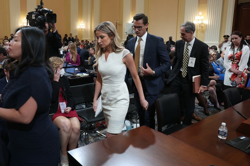 Sarah Matthews (c.), former deputy White House press secretary, departs after testifying before the committee.