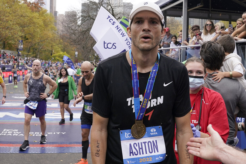 Actor Ashton Kutcher completed his first New York City Marathon, and also raised tons of money for his charity.