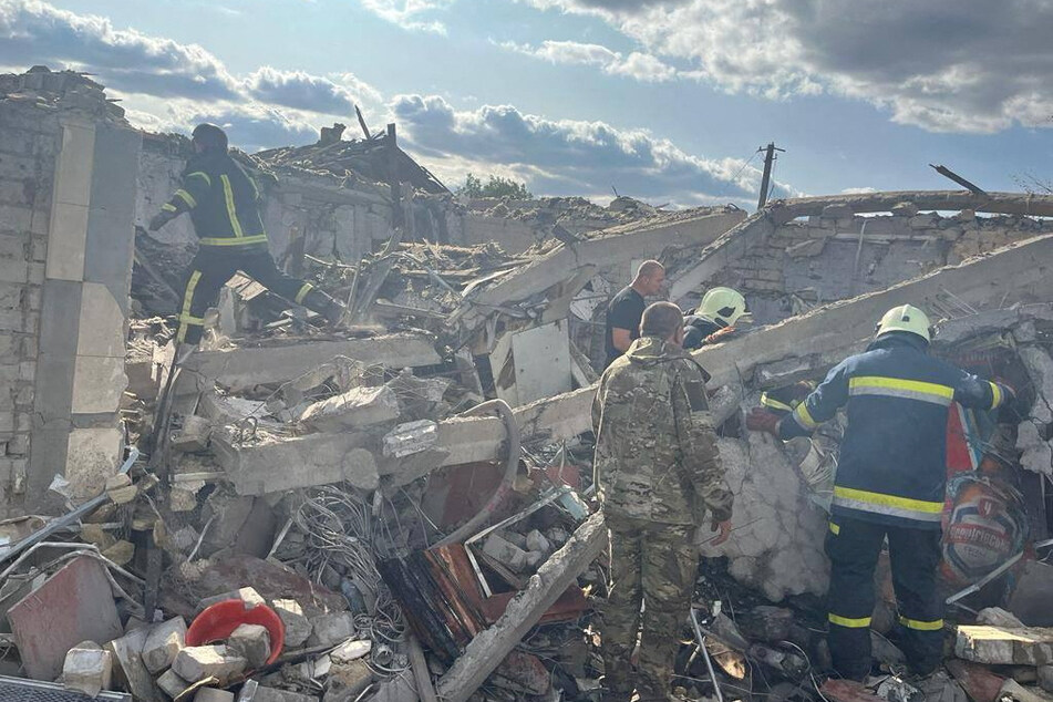 Dozens of people were killed after a Russian missile strike hit a grocery store and café in the Ukrainian village of Hroza.