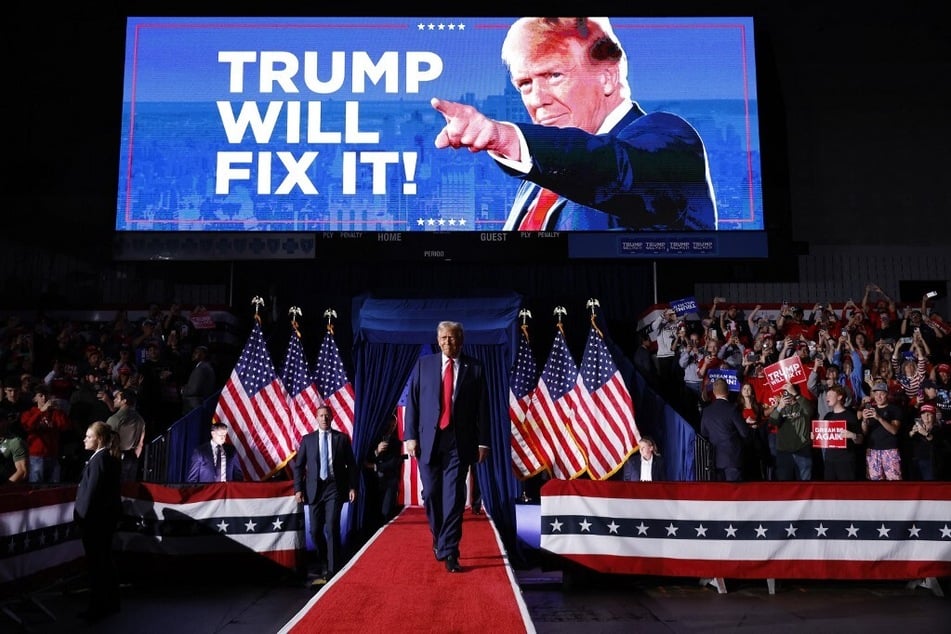 Republican Donald Trump takes the stage for his last 2024 presidential campaign rally at Van Andel Arena in Grand Rapids, Michigan.