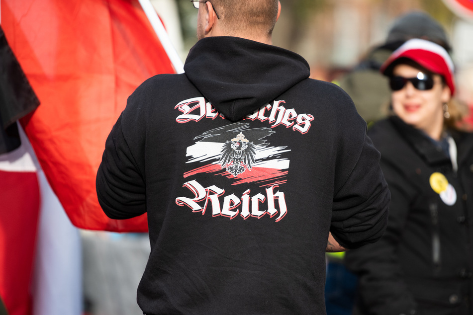 Ein Mann trägt einen Pullover mit dem Aufdruck "Deutsches Reich" bei einer Demonstration von Reichsbürgern. Laut Verfassungsschutz ist deren Zahl in Hamburg noch einmal deutlich gestiegen.