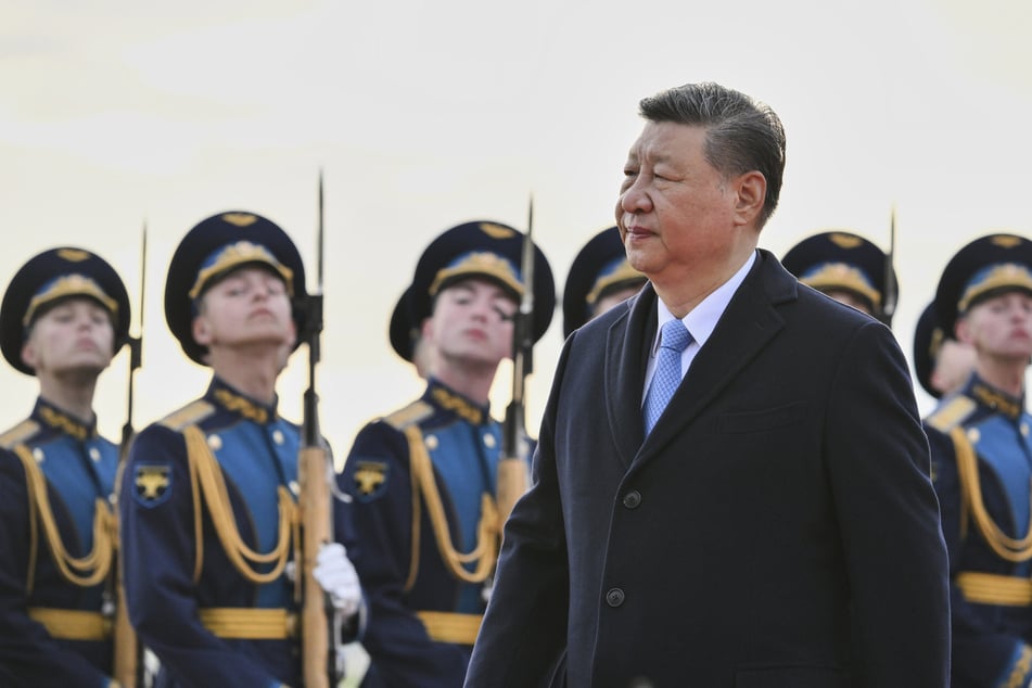 Der chinesische Präsident Xi Jinping geht bei seiner Ankunft auf dem Flughafen Wnukowo in Moskau an russischen Soldaten einer Ehrengarde vorbei.